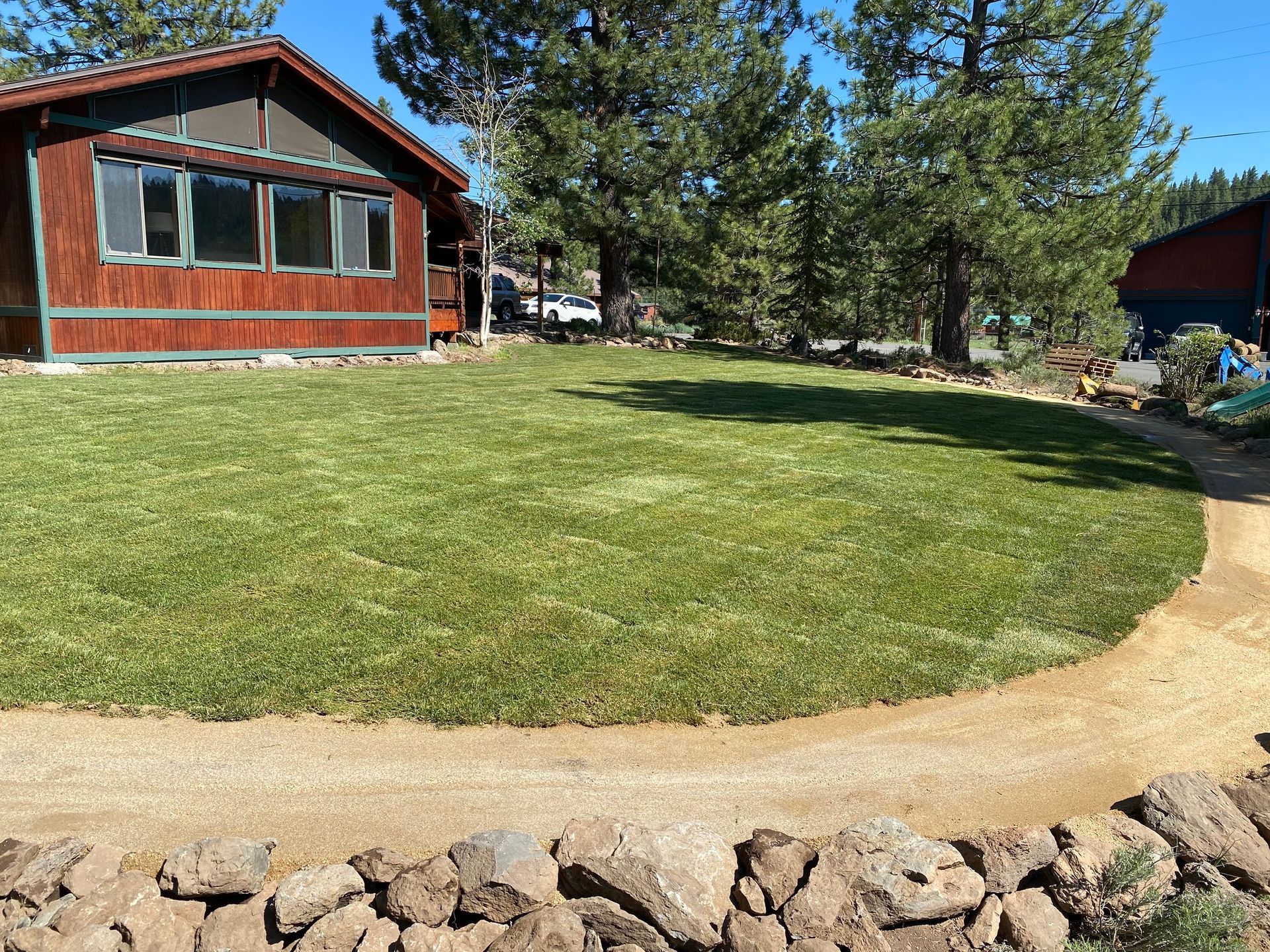A house with a lush green lawn in front of it.
