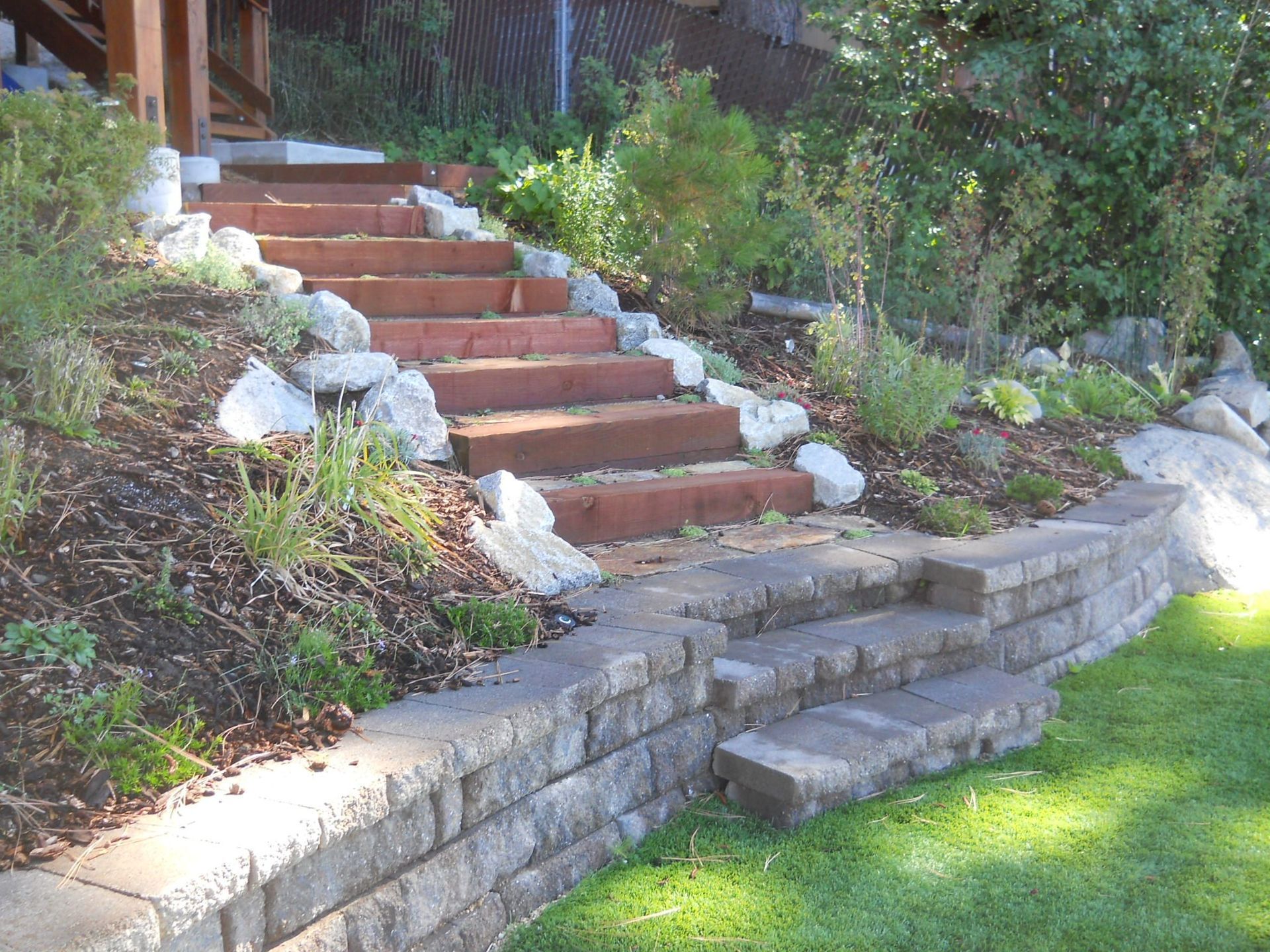 A set of stairs leading up to a lush green hillside