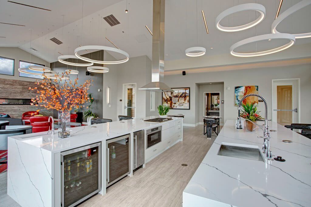 A large kitchen with white counter tops and stainless steel appliances.