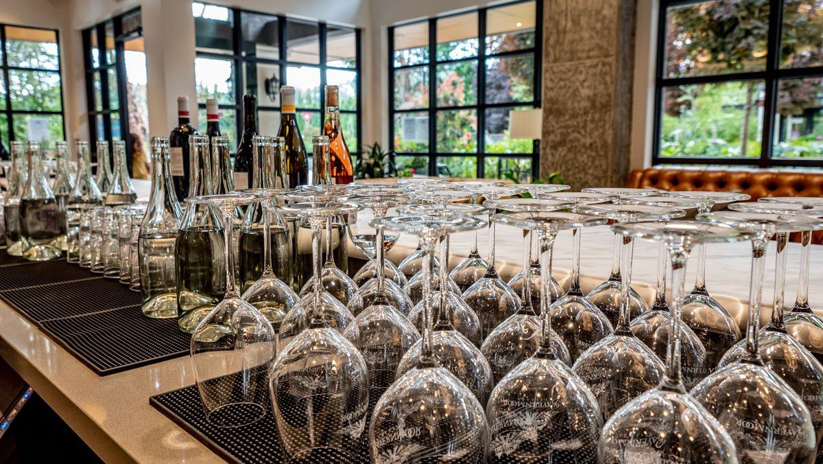 A bar filled with lots of wine glasses and bottles.