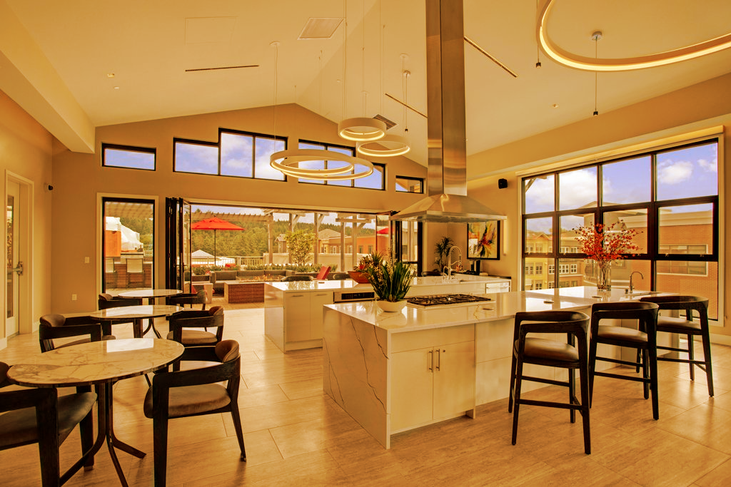 A large room with tables and chairs in it at Woodin Creek Village.