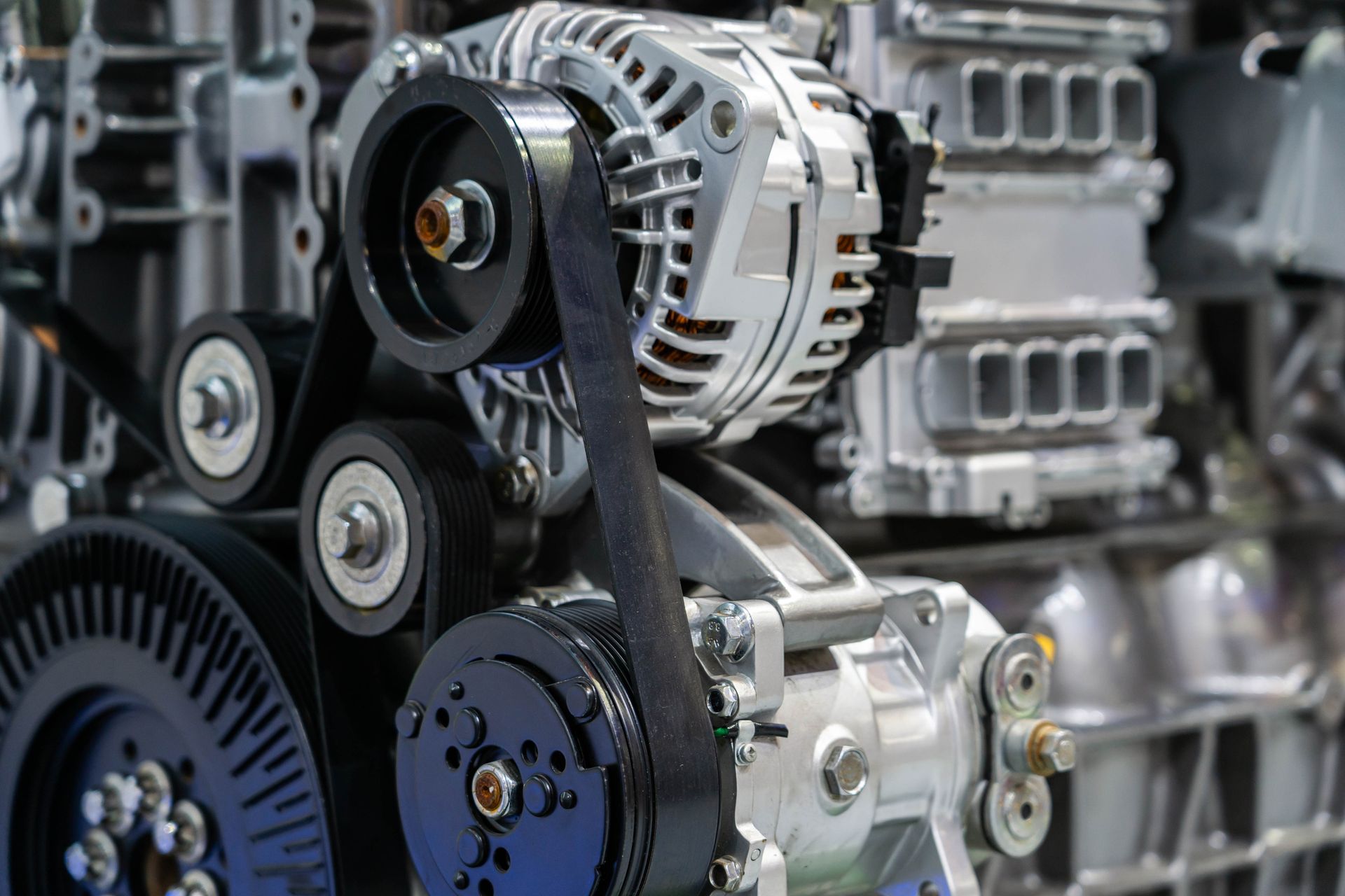 A close up of a car engine with a belt on it.