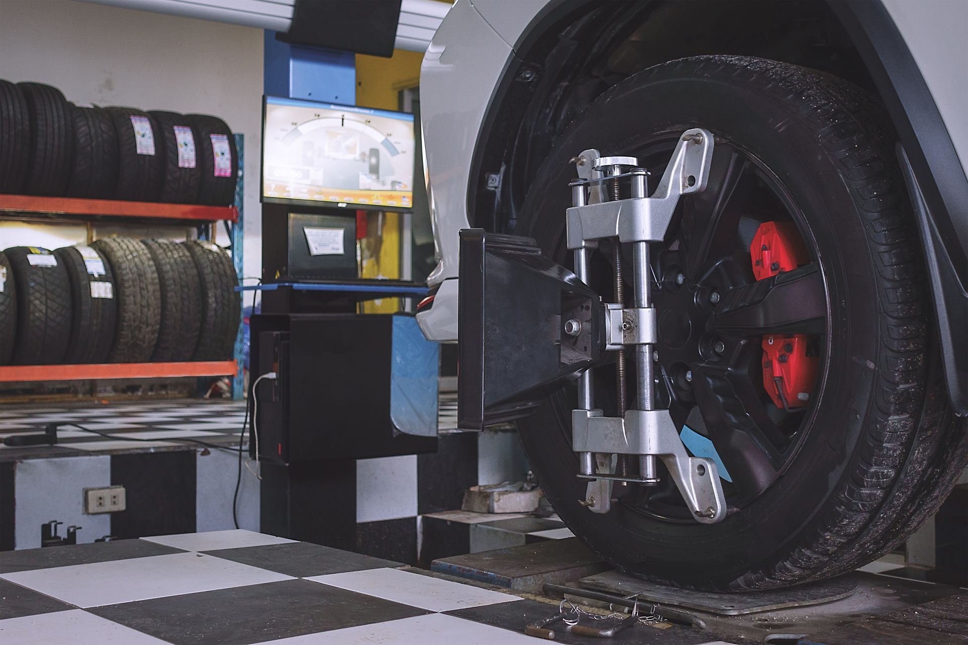 A car is being aligned with a machine in a garage.
