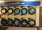 A good year tire store with a lot of tires hanging on the wall.