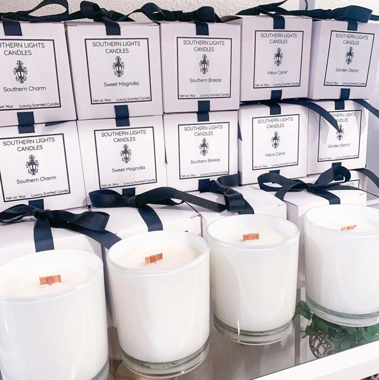 A bunch of white candles are sitting on a table