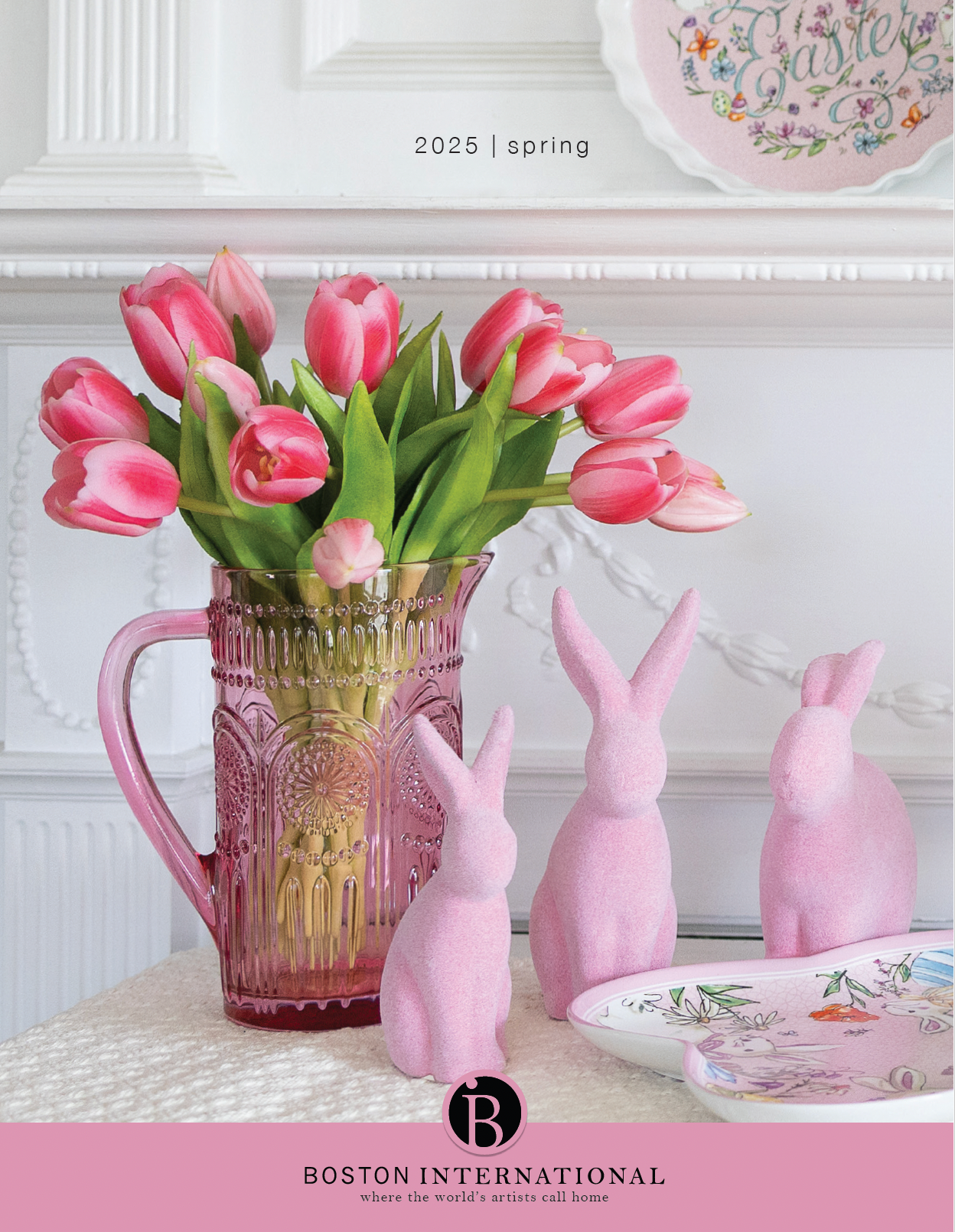 A vase of pink tulips sits on a table next to pink bunny figurines