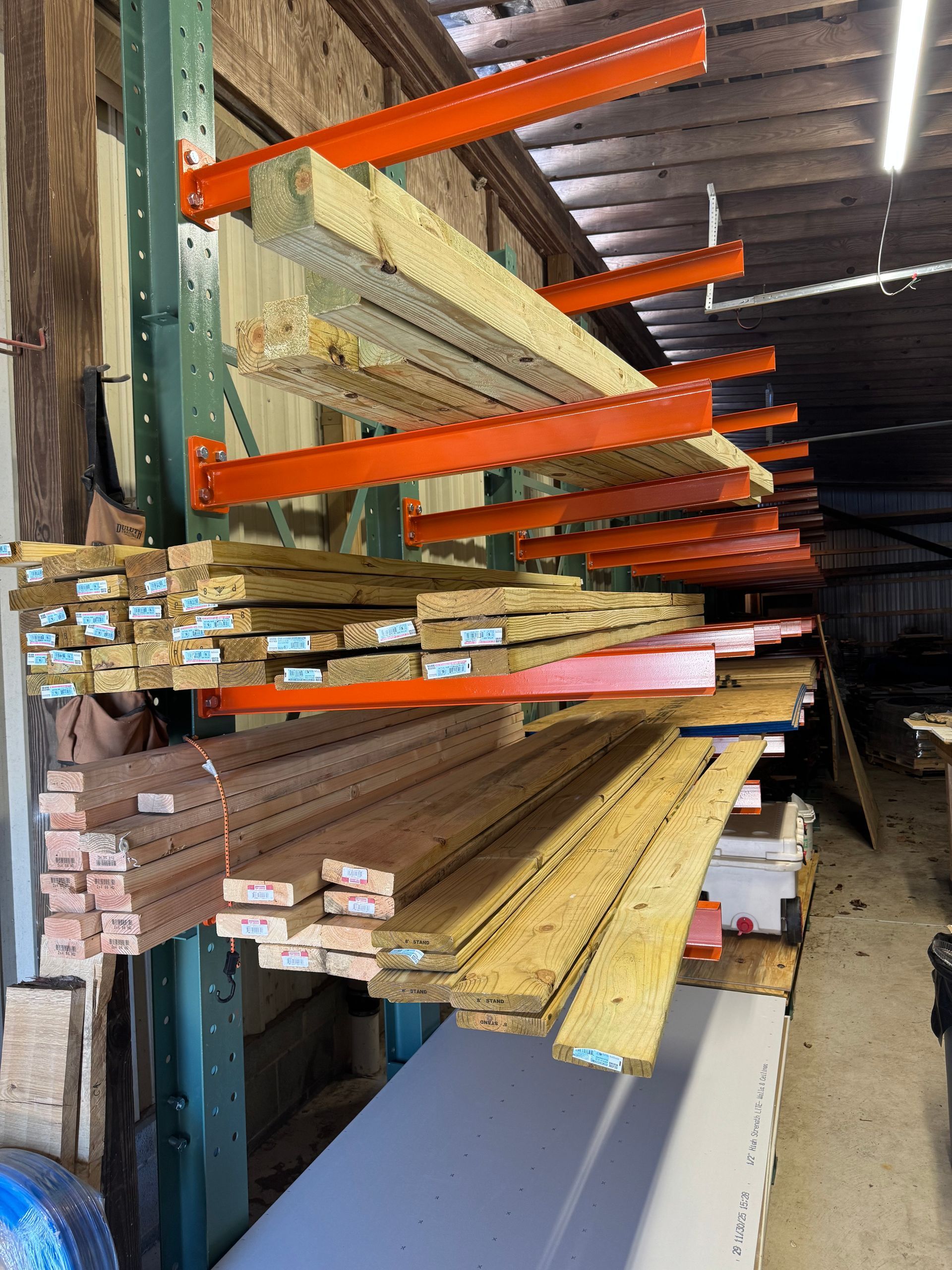 Room under renovation with ladders, debris, and an open doorway.