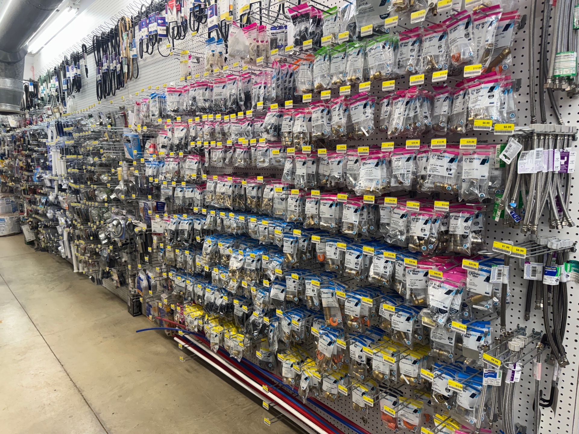 Complex network of shiny metal pipes in an industrial setting.