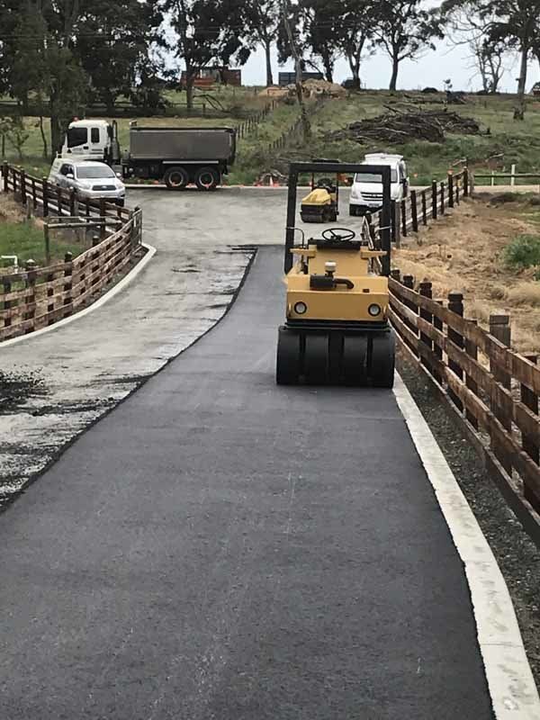 steam roller on newly paved driveway