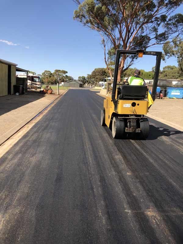 steam roller on newly paved driveway