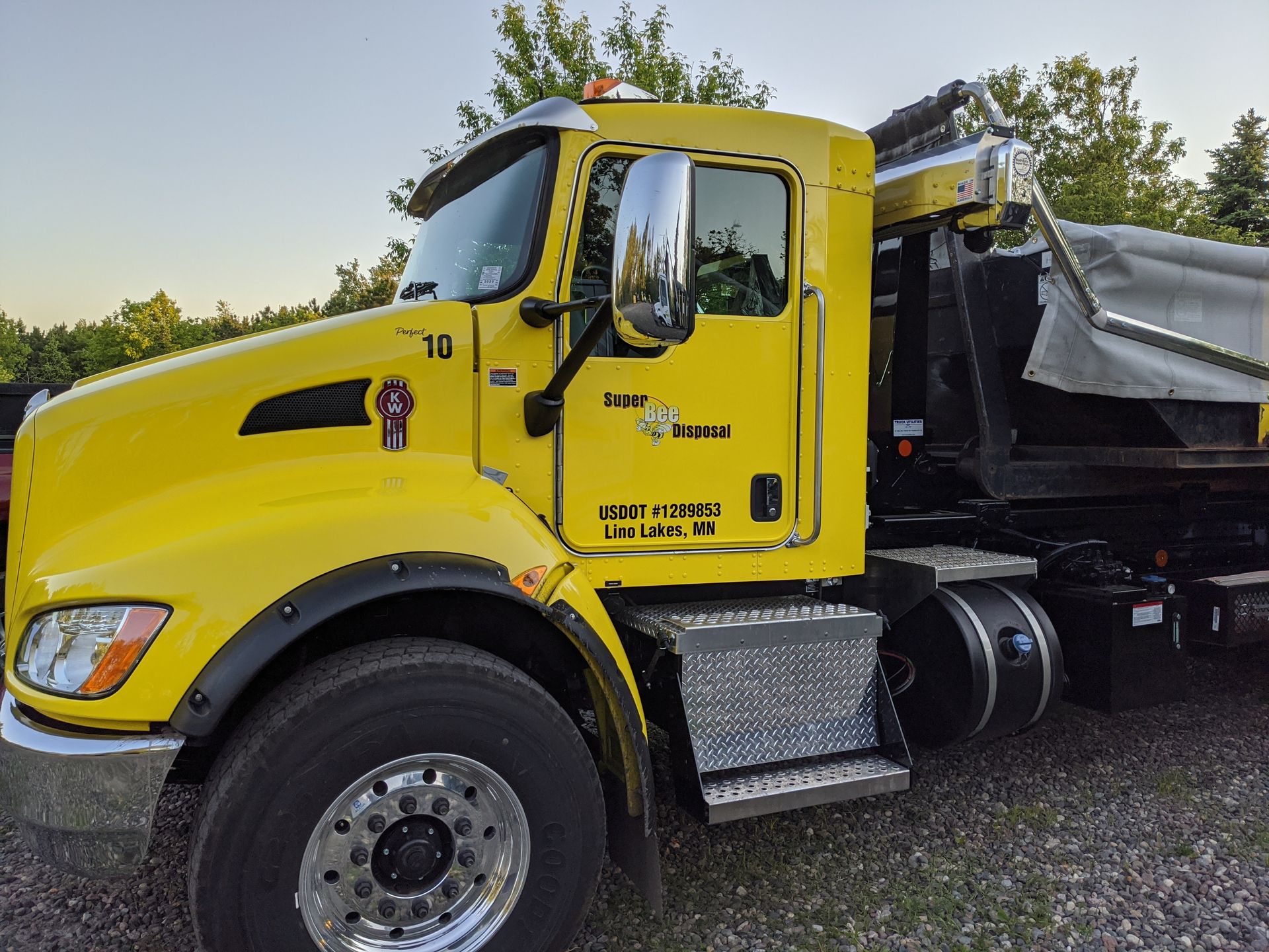 A yellow dump truck with the number 10 on it