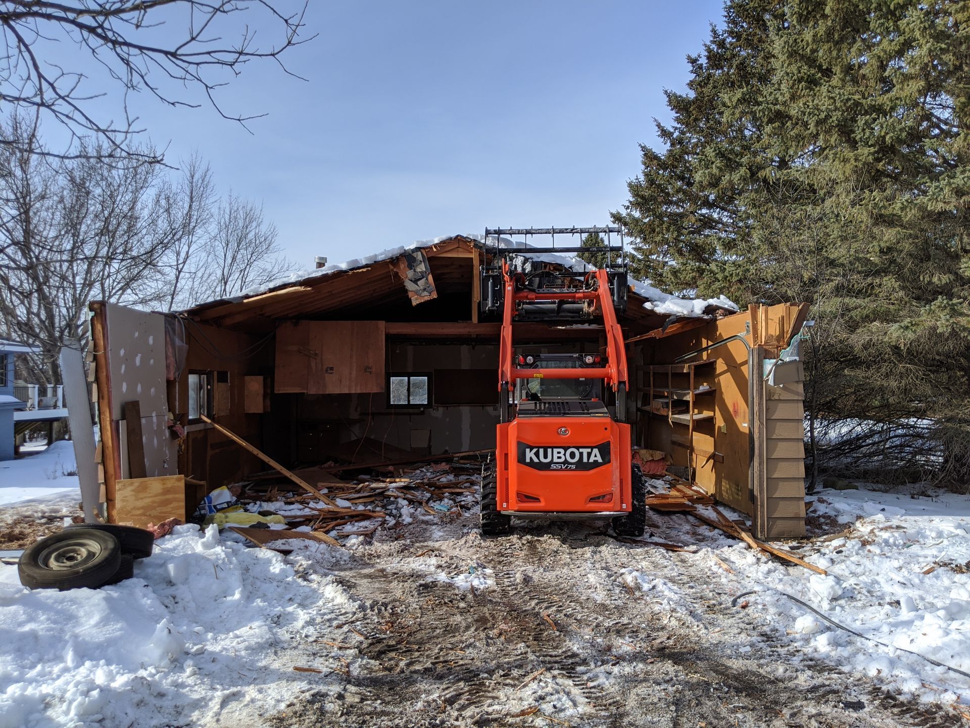 a kubota tractor is being used to demolish a building