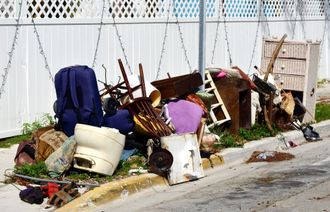 A pile of trash is sitting on the side of the road