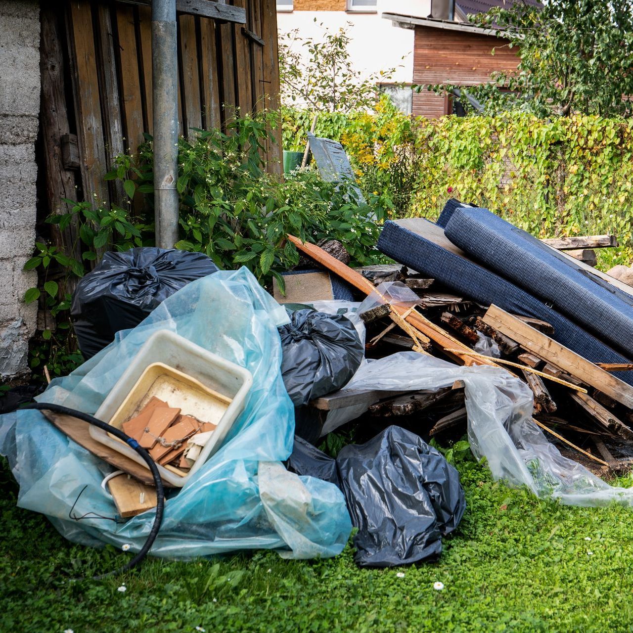 A pile of trash is sitting on top of a lush green lawn.