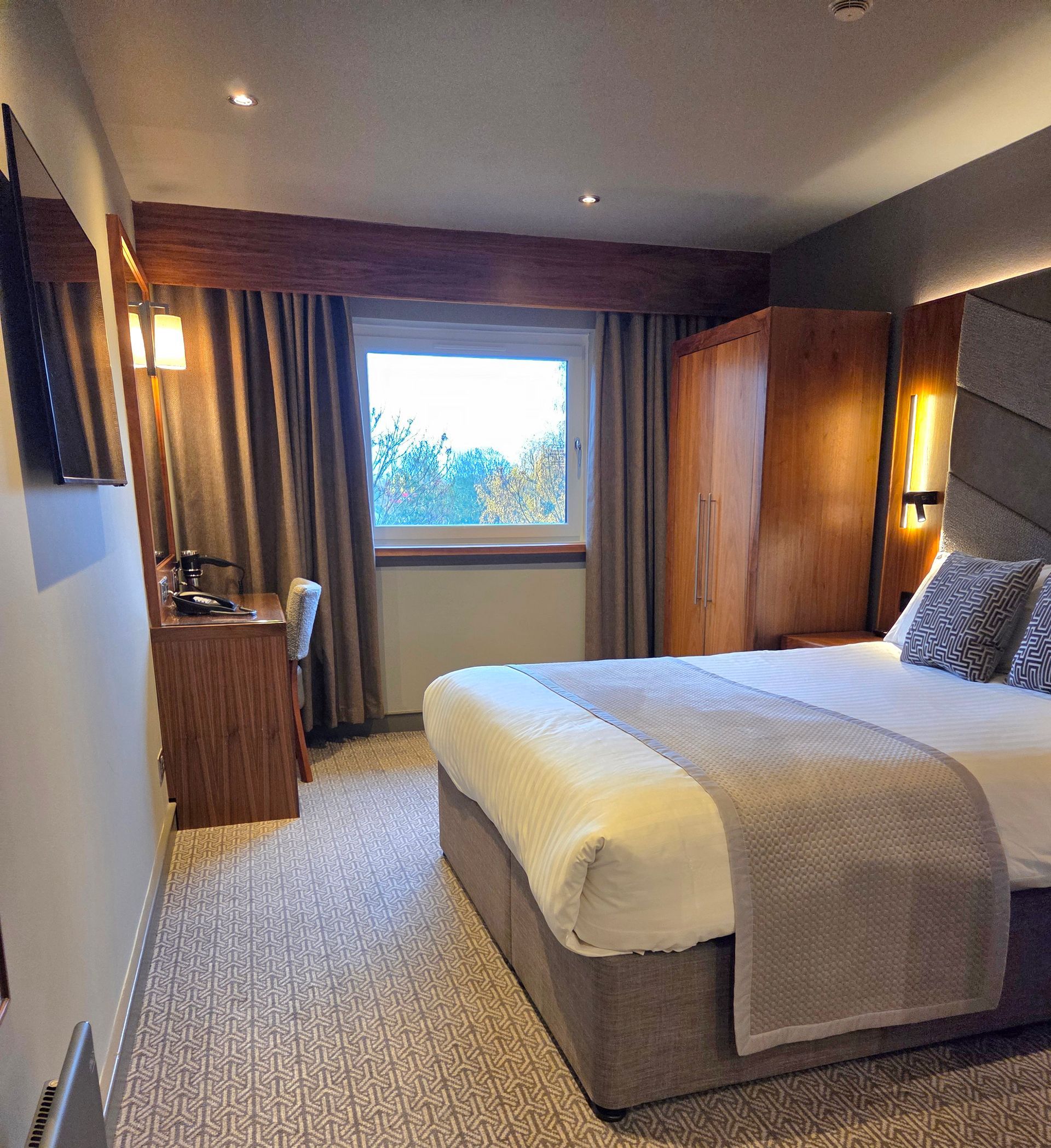 Smoked salmon and poached egg on toast with balsamic glaze on a plate, with silverware on a napkin.