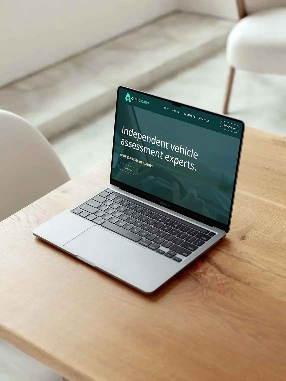 Laptop on wooden table displaying website; 