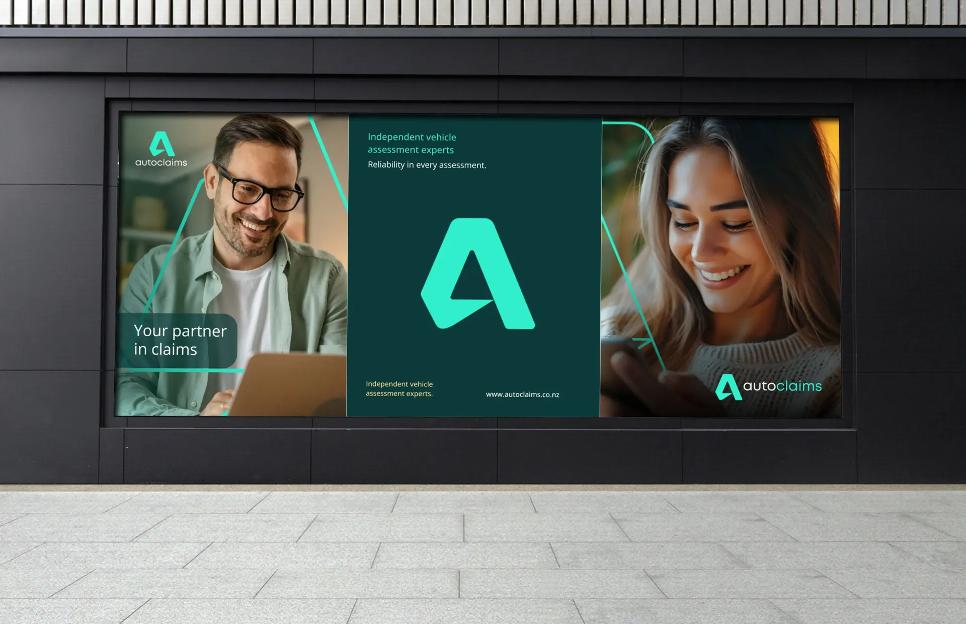 Billboard with smiling people, teal logo, and text on a black wall in a modern setting.