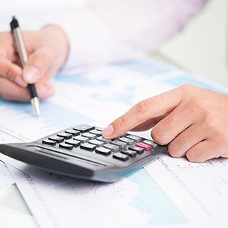 Accountant Using Calculator - Tax Preparation in Hanover, MA