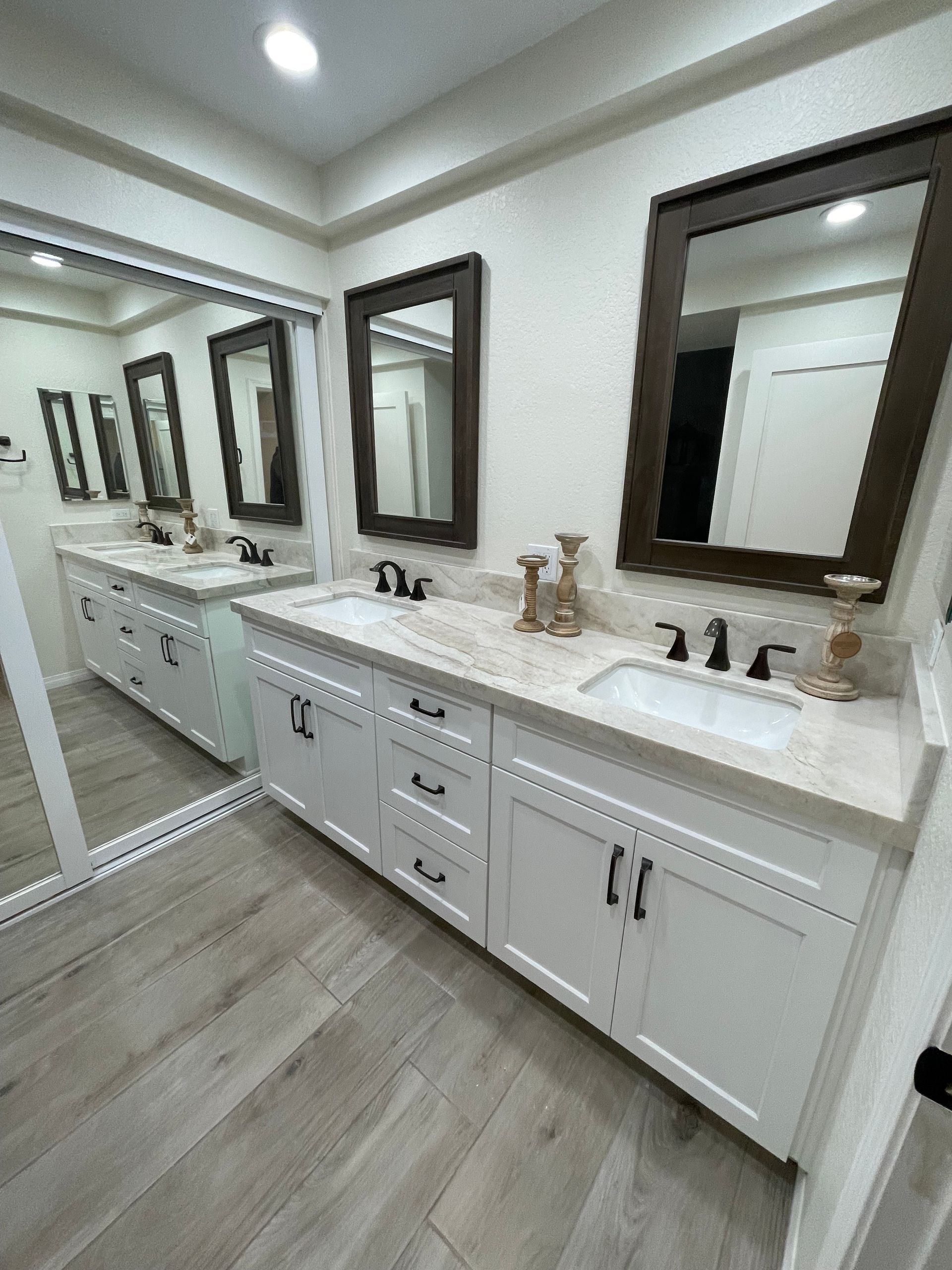 A bathroom with two sinks and two mirrors.