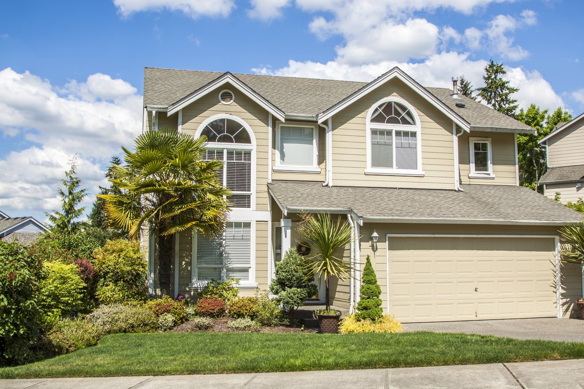 a large house with a garage and a lot of windows