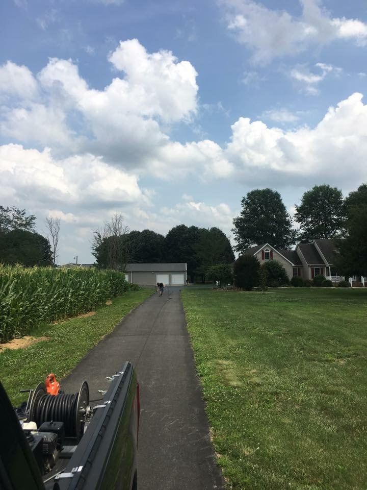 a truck is parked on the side of a road next to a house .
