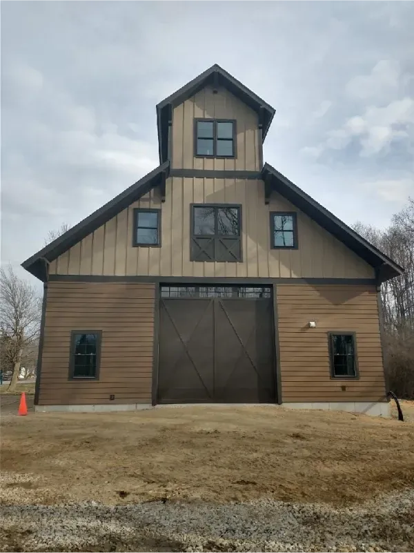 A large brown building with a large garage door