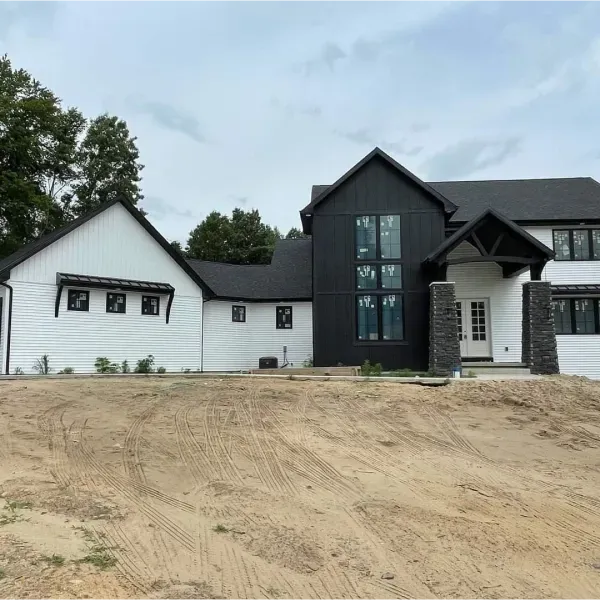 A black and white house with a lot of windows