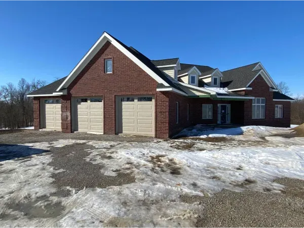 A large brick house with a white garage door