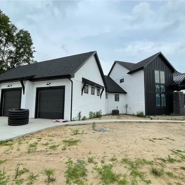 A white house with black trim and a black roof