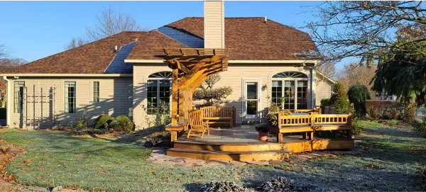 A large house with a statue in front of it