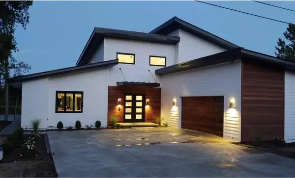 A large white house with a garage and a driveway