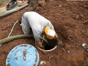Gecko Enterprises employee working in septic dig hole