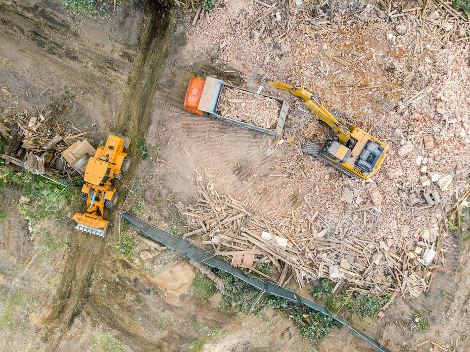An aerial view of a construction site with a bulldozer and a truck.