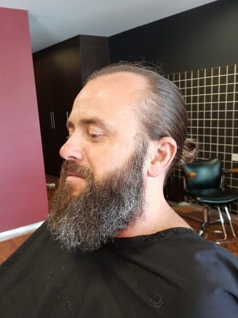 Man With Long Beard And Hair Pulled Back — Bolton Brothers Barbers in Erina, NSW