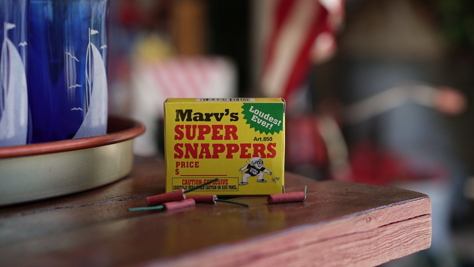 A box of super snappers is sitting on a wooden table.