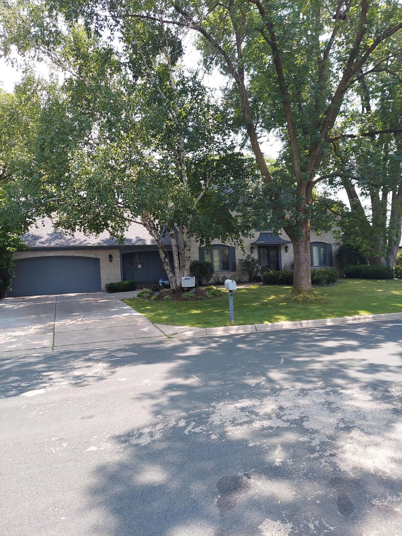A house with a lot of trees in front of it