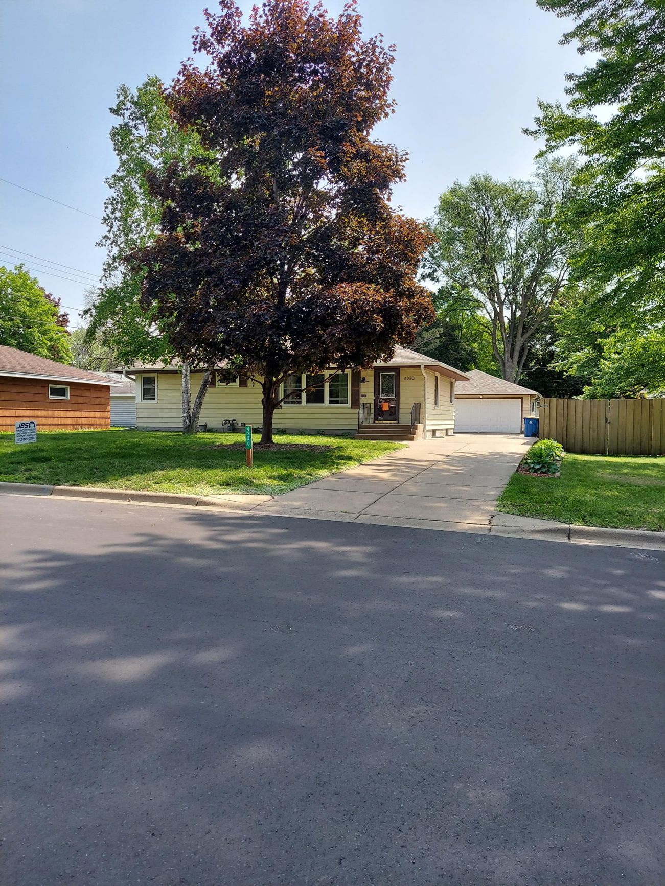 A house with a large tree in front of it