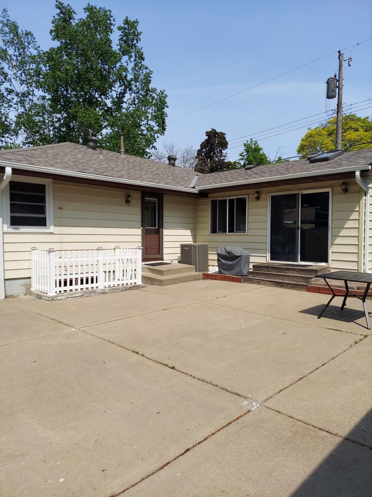 A house with a picnic table in front of it