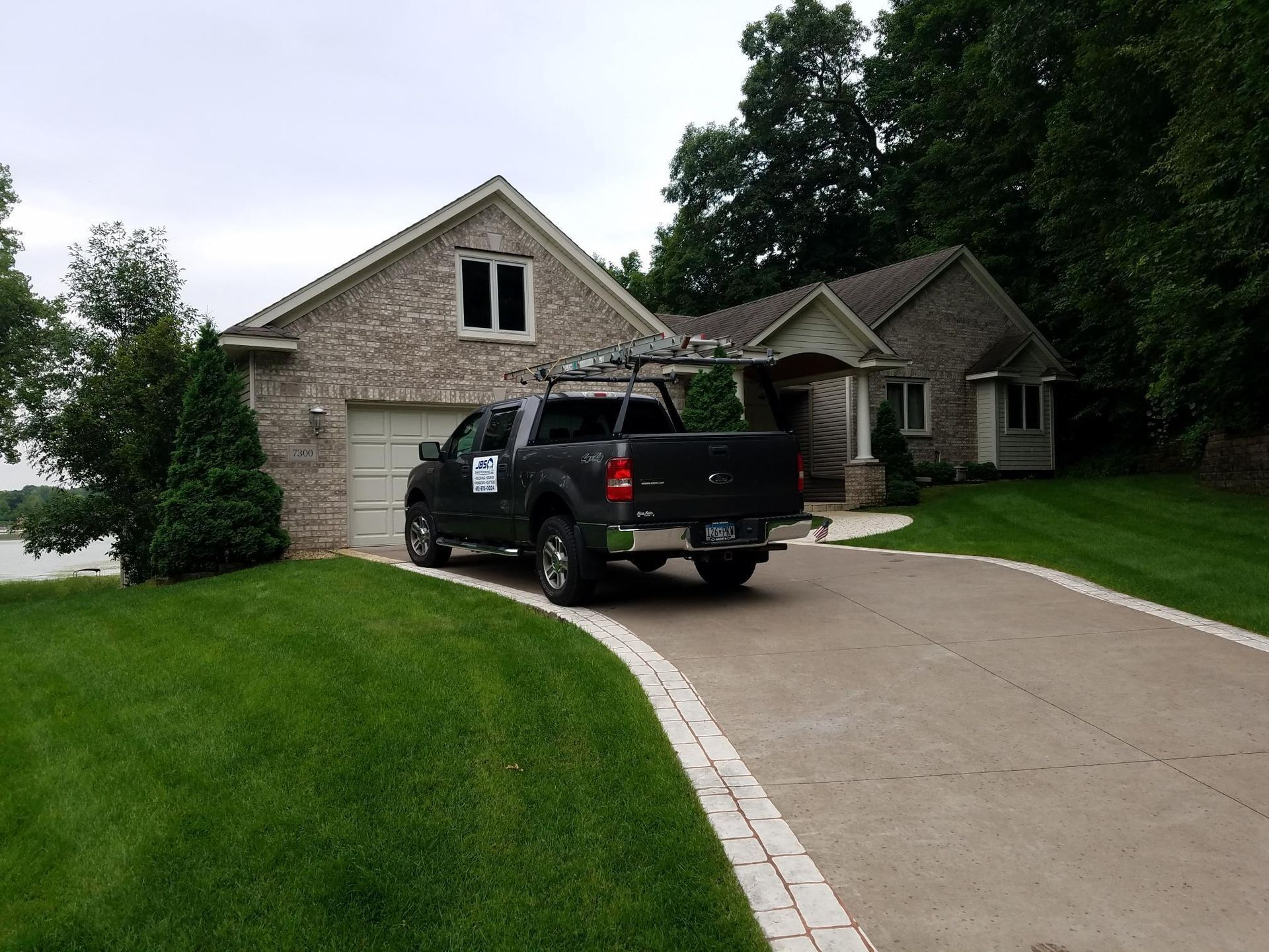A black truck is parked in front of a house