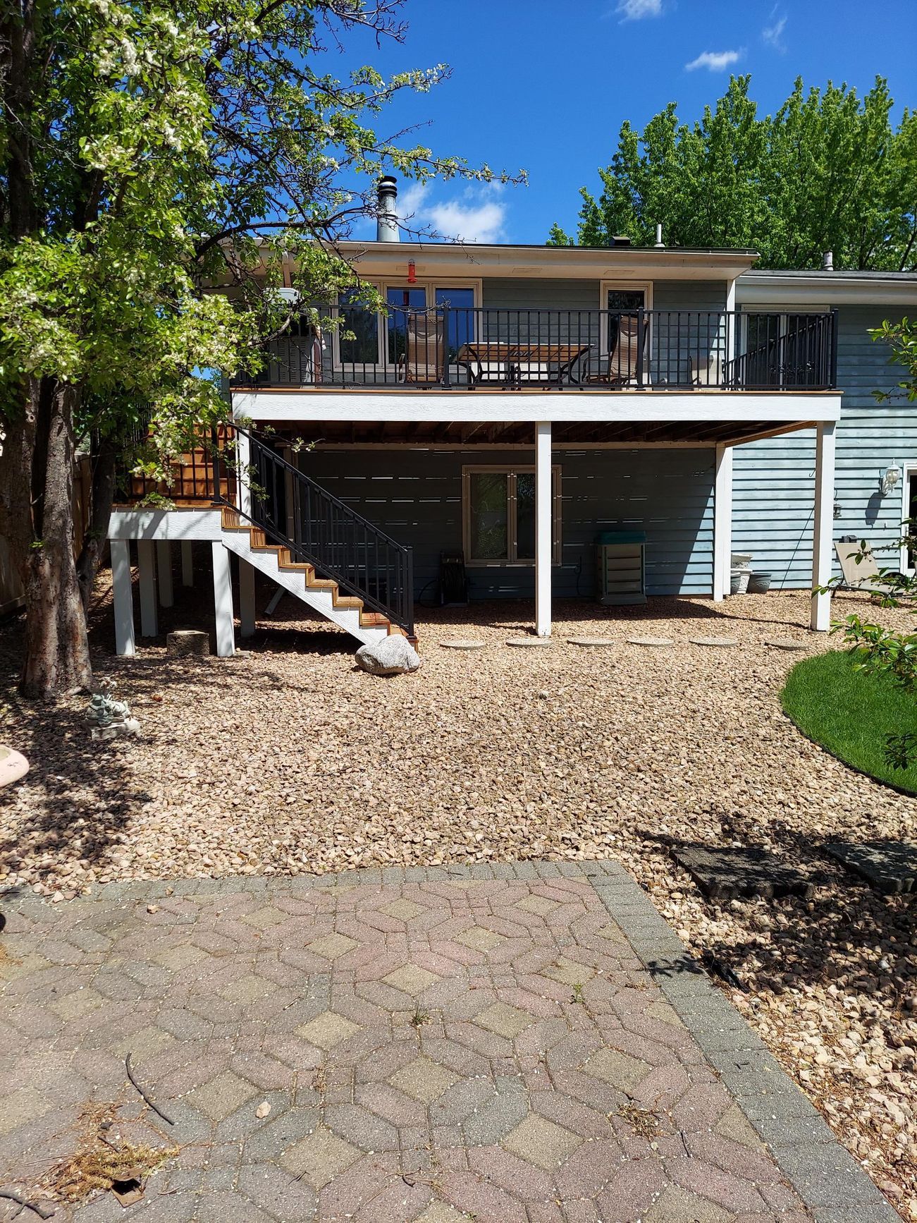 A house with a large deck and stairs leading up to it.