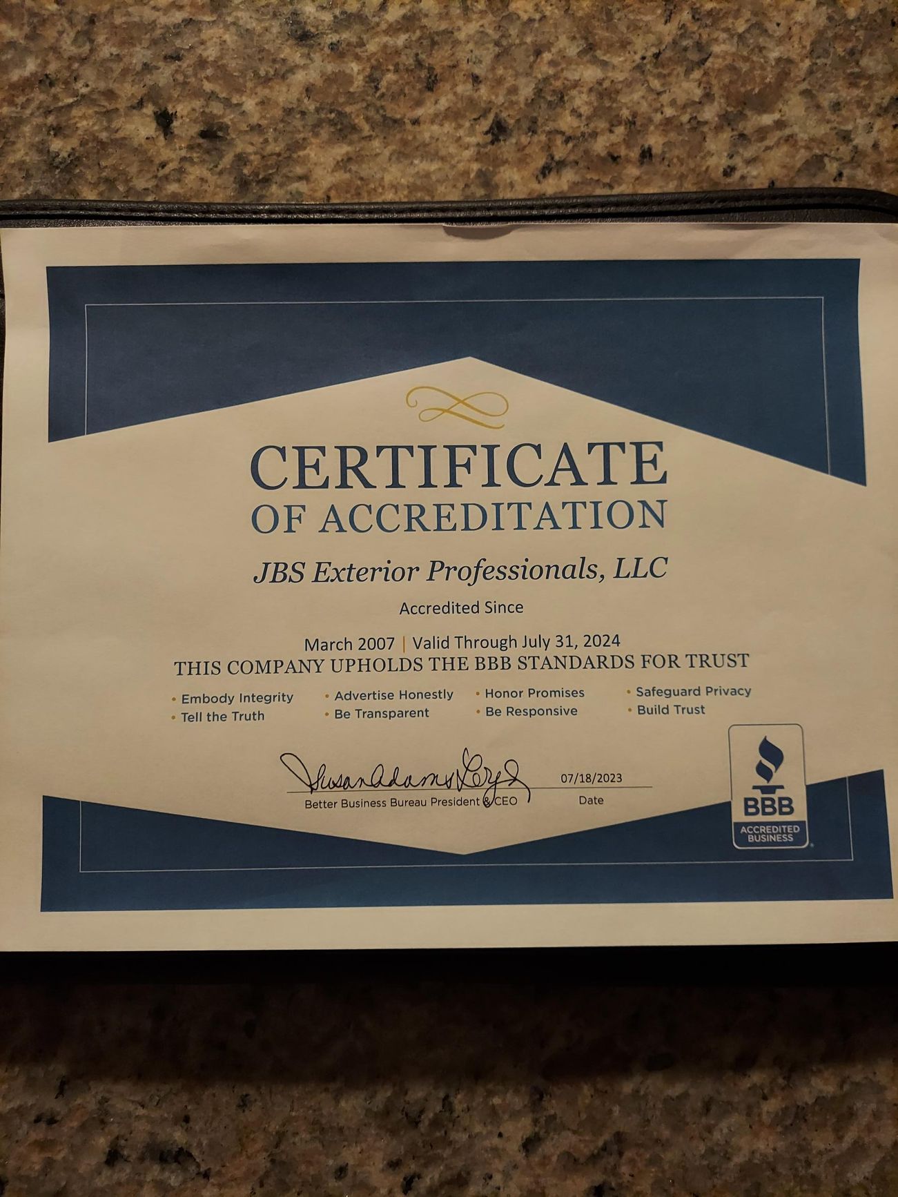 A certificate of accreditation is sitting on a table