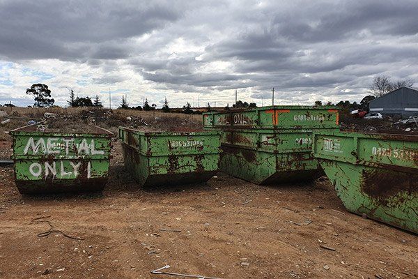 large green scrap metal bins