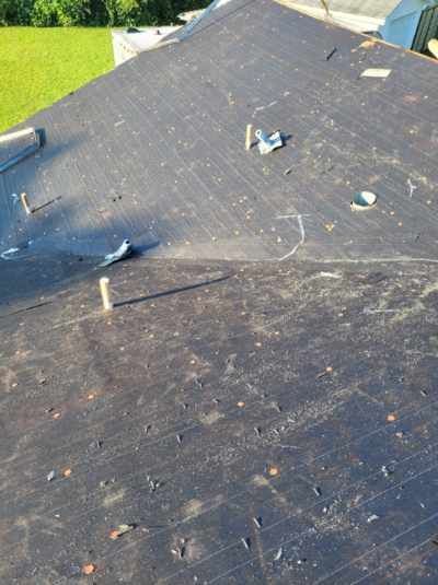 A close up of a roof with a lot of nails on it.