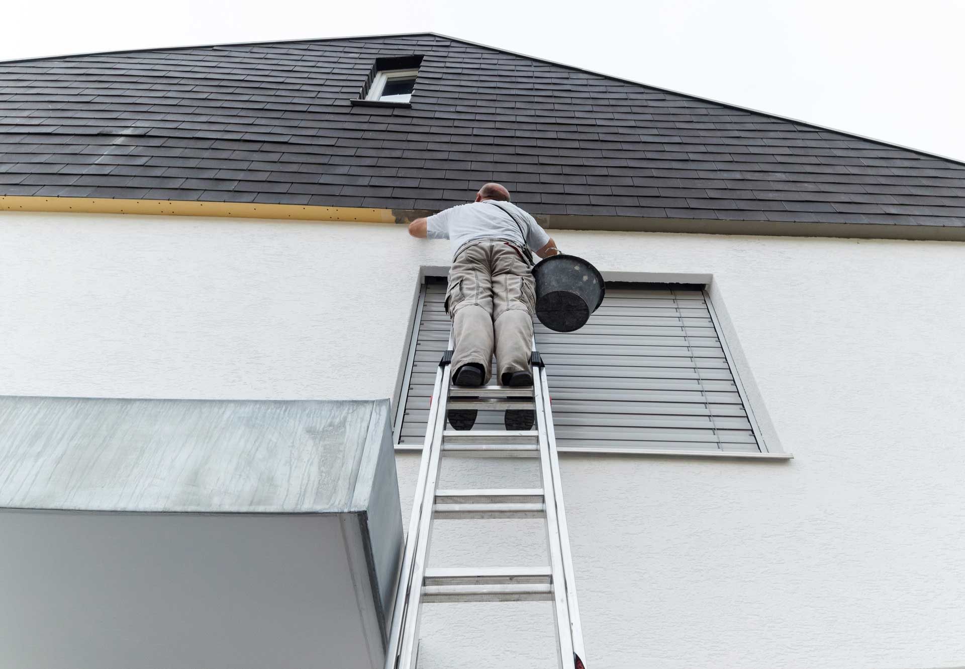 Person on a ladder climbing a ladder.