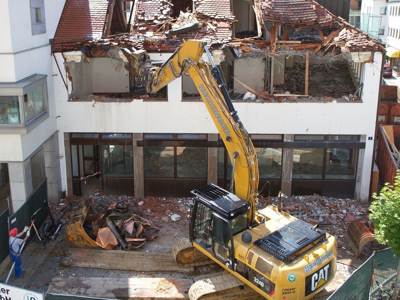 excavator tearing down walls of a home. 