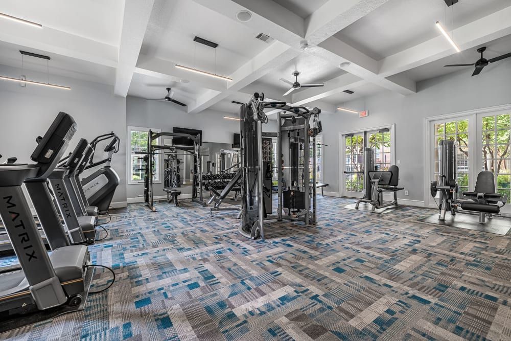 A large gym filled with lots of exercise equipment at Marquis at Silver Oaks in Grapevine, TX.
