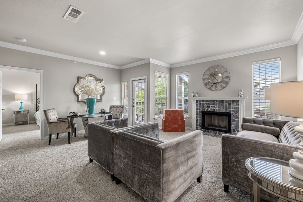 Apartment living room filled with furniture and a fireplace at Marquis at Silver Oaks in Grapevine, TX.