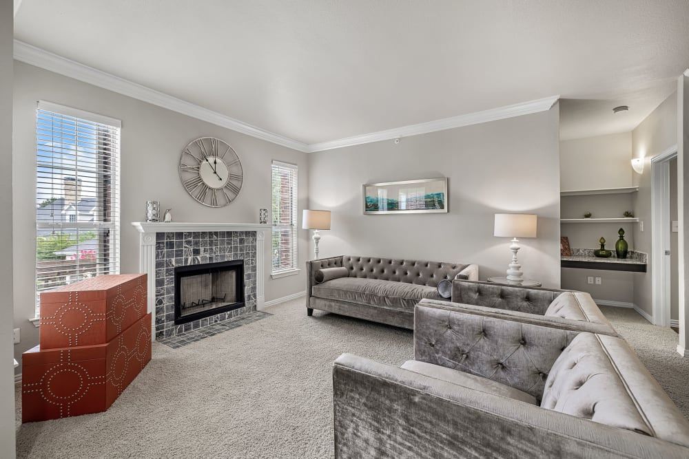 A modern living room filled with furniture, a fireplace, and decor at Marquis at Silver Oaks in Grapevine, TX.