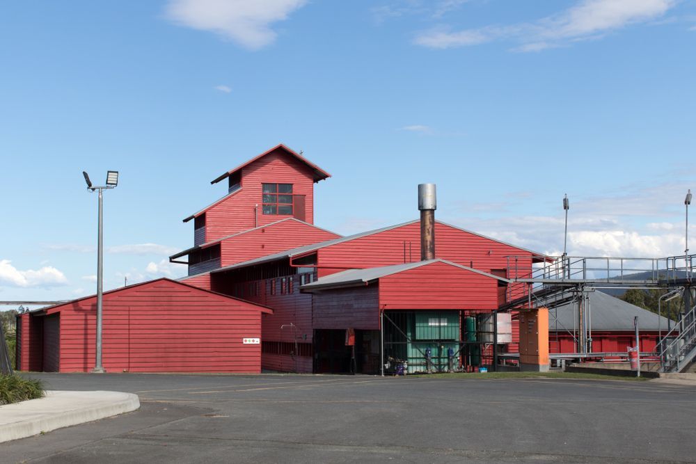 A Large Red Building With A Blue Sky In The Background — Trusted Energy Solutions In Beenleigh, QLD