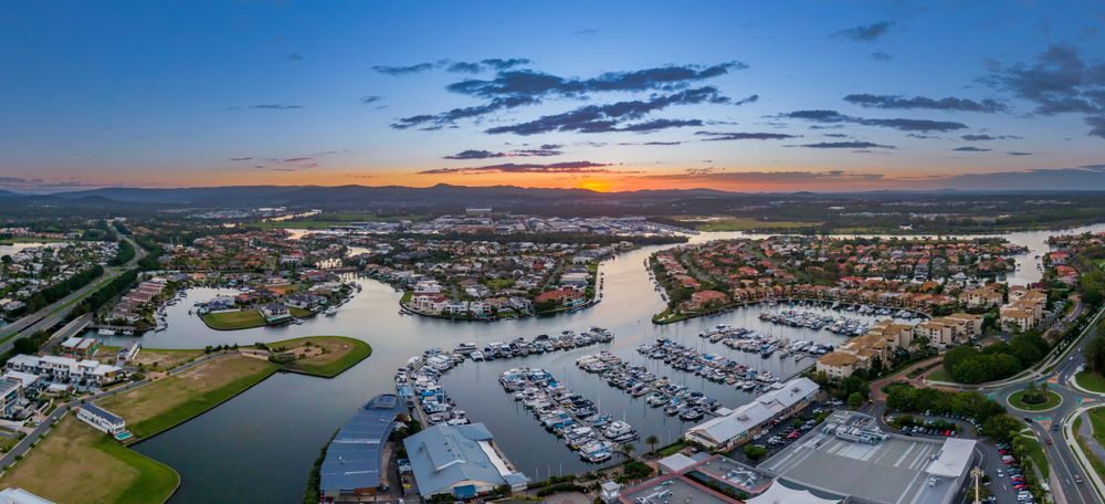 There is a Boat in the Distance on the Beach — Trusted Energy Solutions In Hope Island, QLD